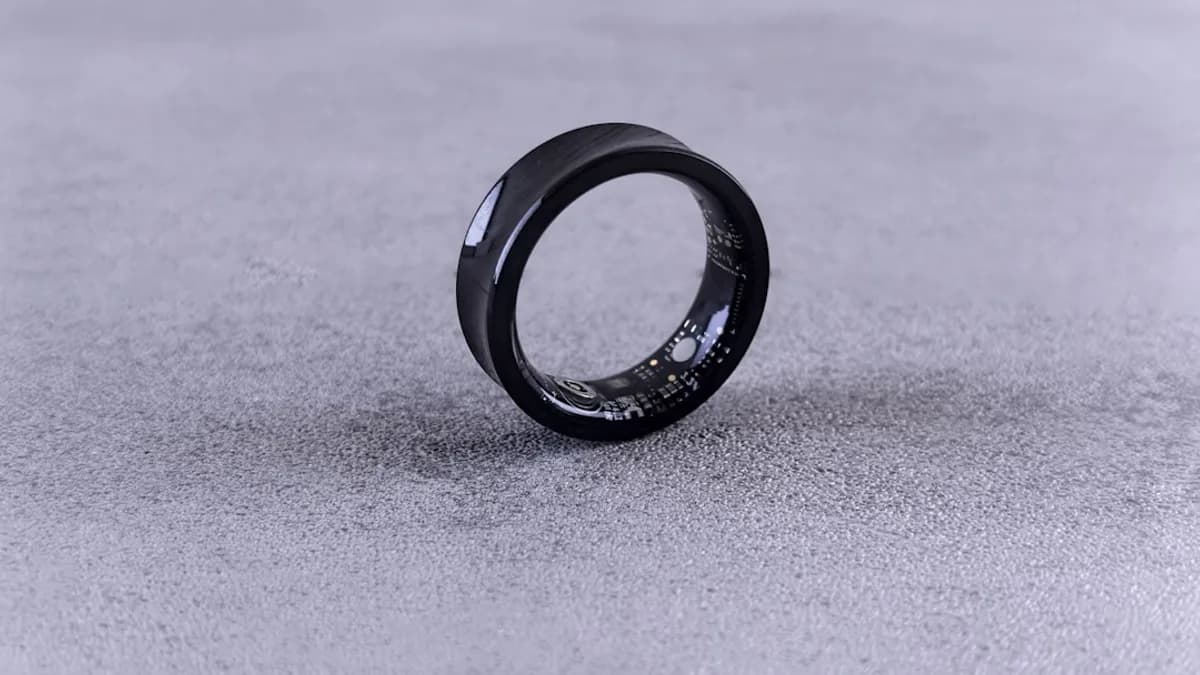 A black ring with white speckles on a gray surface