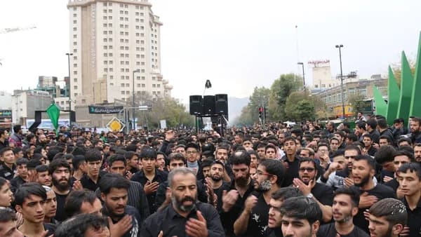 crowd of people gathered near high-rise building