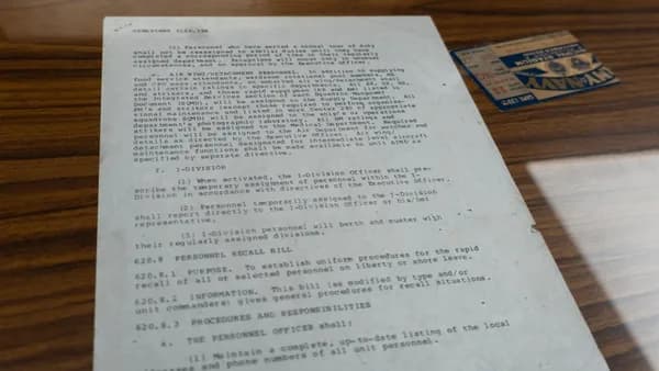 Old document with text and small card.