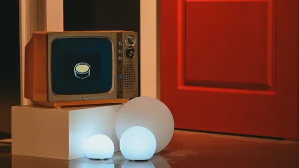 Vintage television displays glowing button next to orb lights.