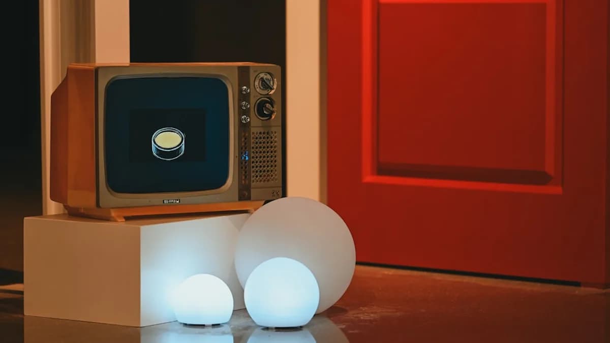 Vintage television displays glowing button next to orb lights.