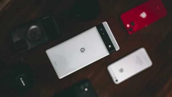 a group of cell phones sitting on top of a wooden table