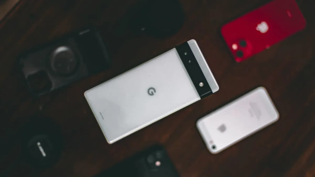 a group of cell phones sitting on top of a wooden table