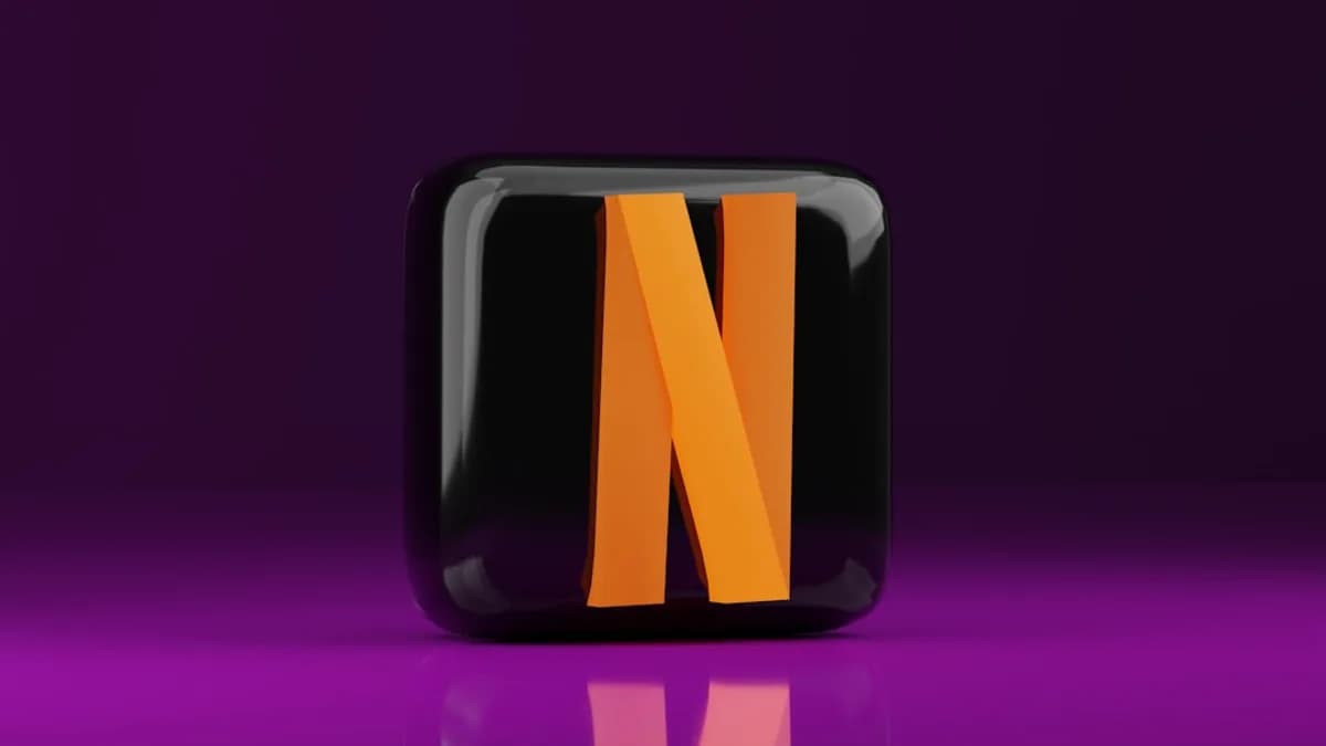 A black and orange letter n on a purple background