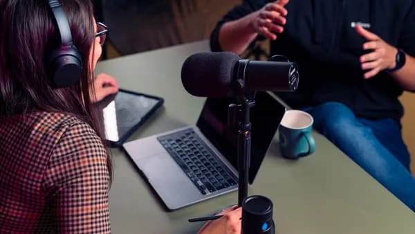 a person with headphones on using a laptop