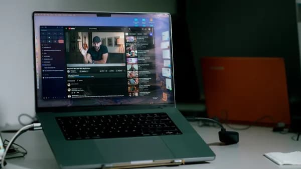 a laptop computer sitting on top of a white desk