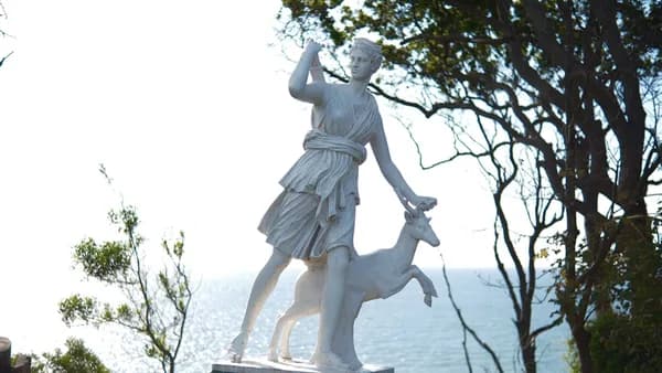 A statue of a woman holding a deer
