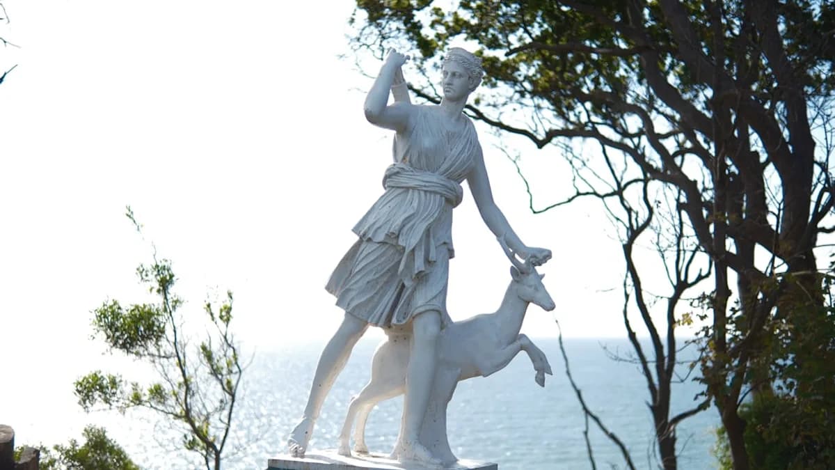 A statue of a woman holding a deer