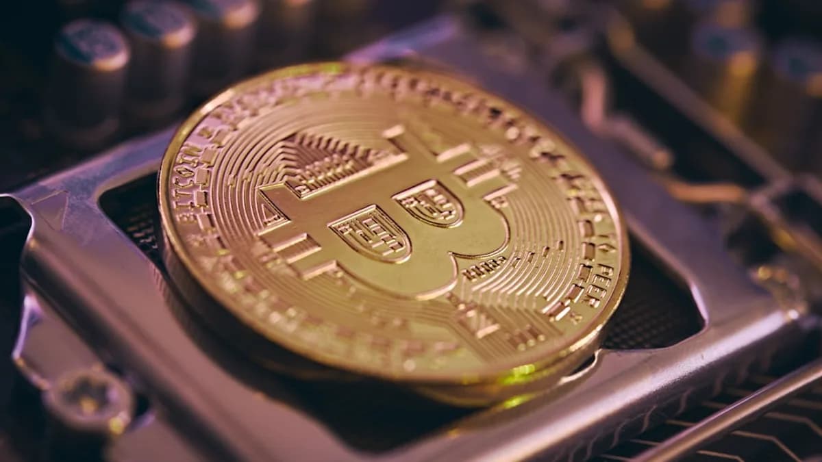 a bit coin sitting on top of a computer processor