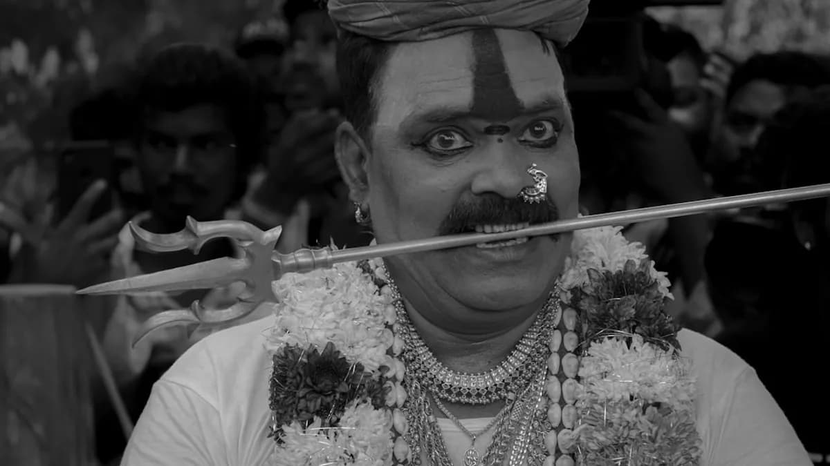 Man with sword through mouth and garlands