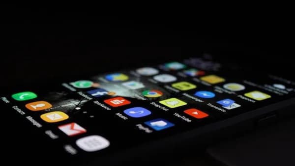 black smartphone with charger cord connected