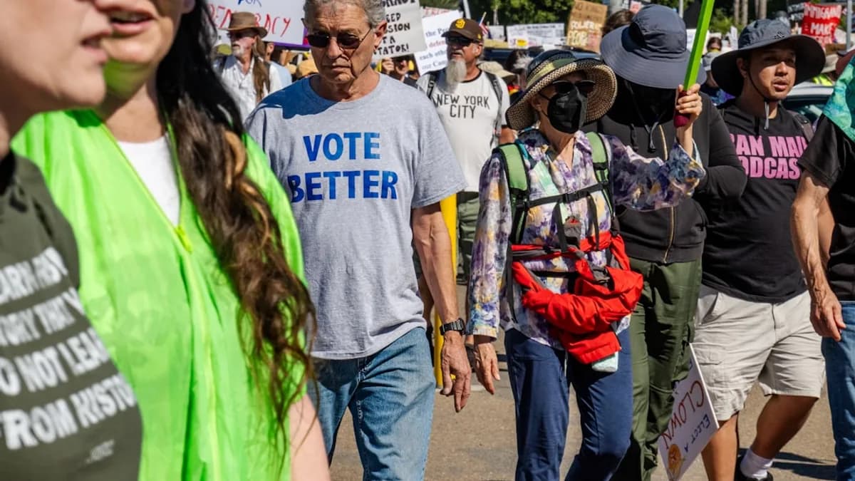 People marching with protest signs and shirts
