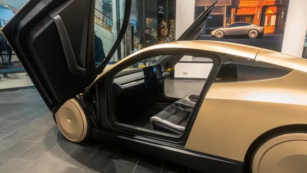 A car with its door open on display in a museum