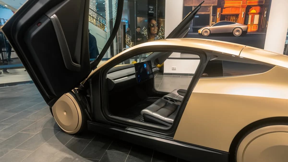 A car with its door open on display in a museum