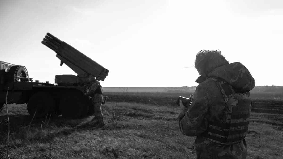 a man standing next to a truck in a field