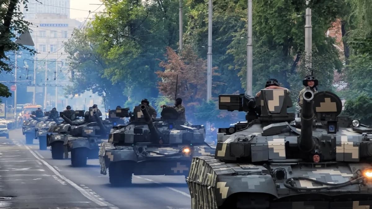 A group of tanks driving down a street