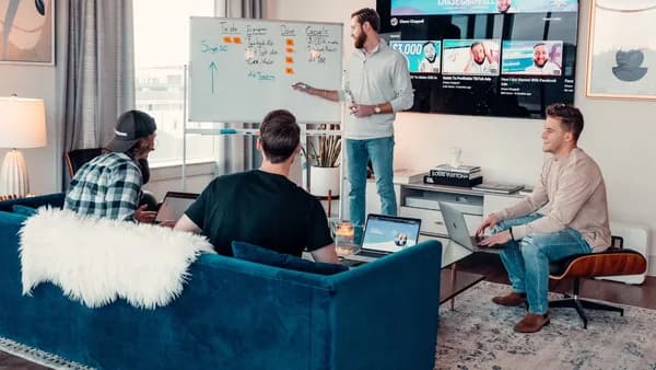 a group of people sitting around a living room
