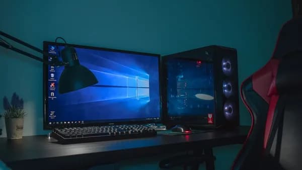 turned on desktop computer set with black and gray leather gaming chair