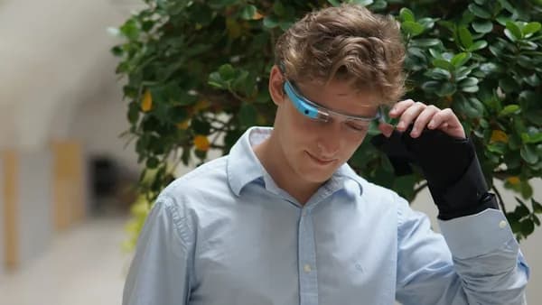 man in blue dress shirt wearing blue framed eyeglasses
