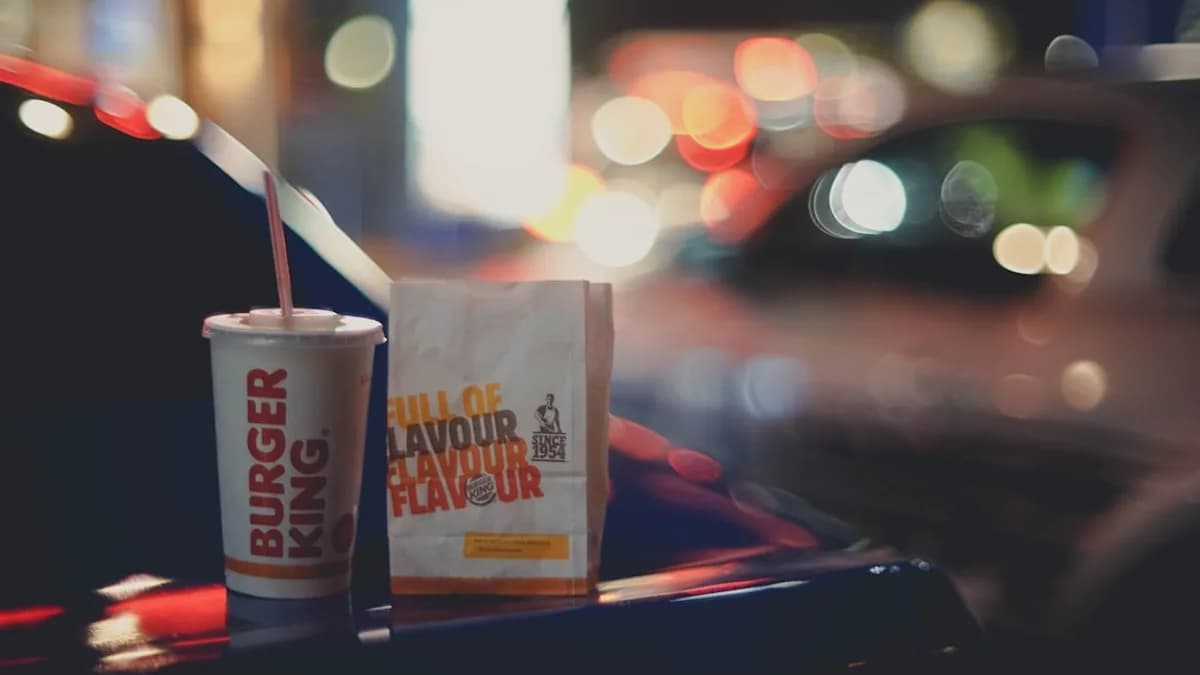 Burger king cup and bag with blurred city lights