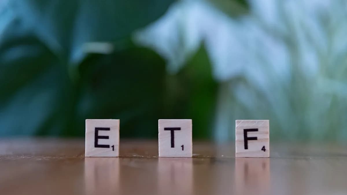 A wooden block spelling the word etf on a table