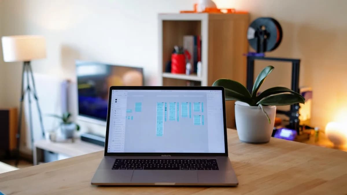 macbook pro on brown wooden table