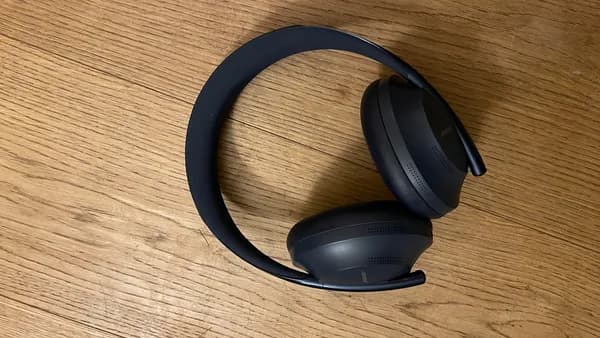a pair of headphones sitting on top of a wooden table