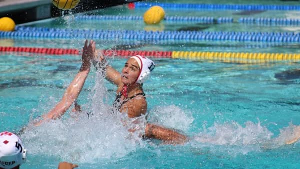 woman in swimming pool with yellow and black volleyball
