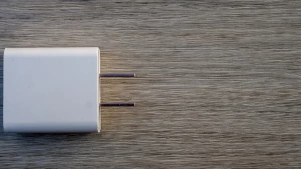 White electrical adapter on a wooden surface