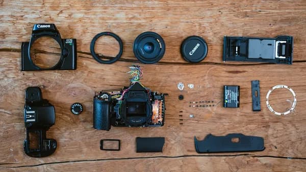 a wooden table topped with different types of cameras