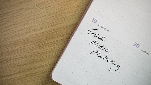 a notepad with the words social media marketing written on it