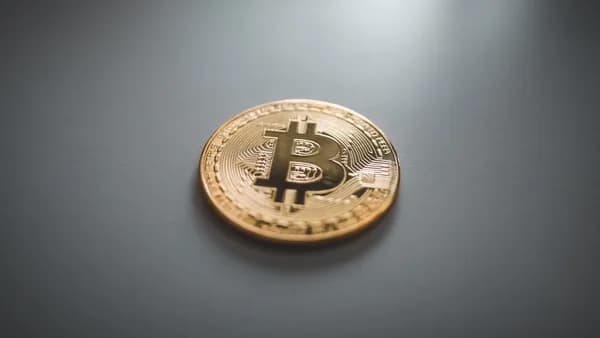 gold round coin on gray surface