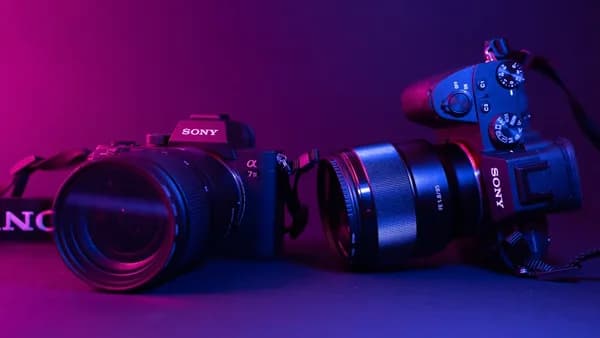 black nikon dslr camera on blue surface