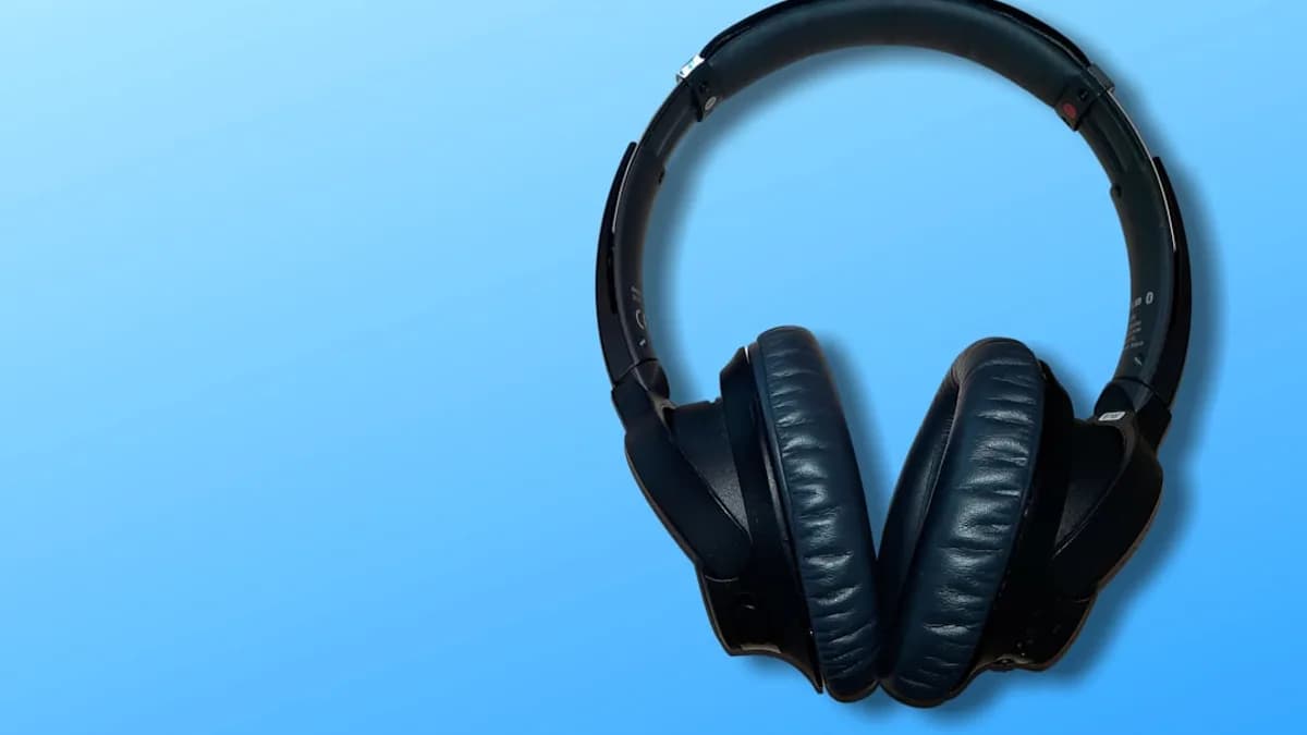 black corded headphones on blue background