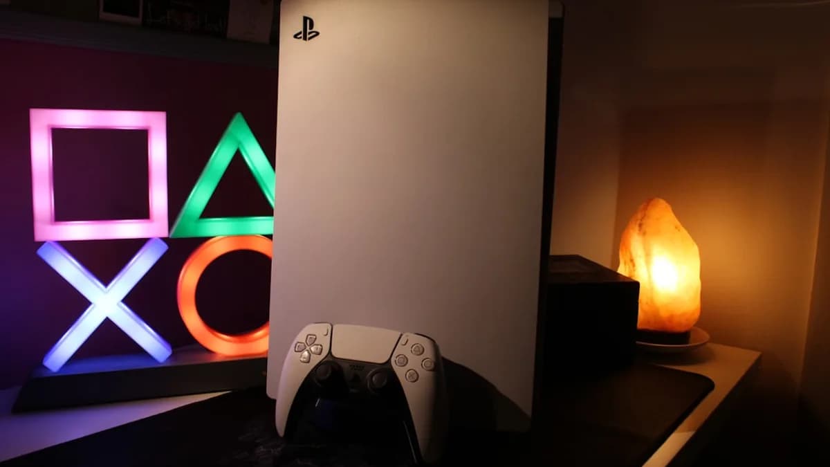 a video game console next to a neon sign