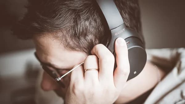 man using black Sony headphones