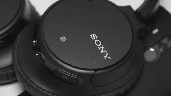 black Sony cordless headphones on white surface