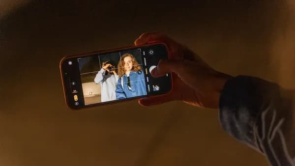 a person taking a picture with a cell phone