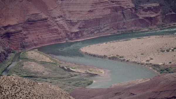 a river running through a canyon surrounded by mountains