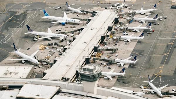 white and gray airplane on airport during daytime