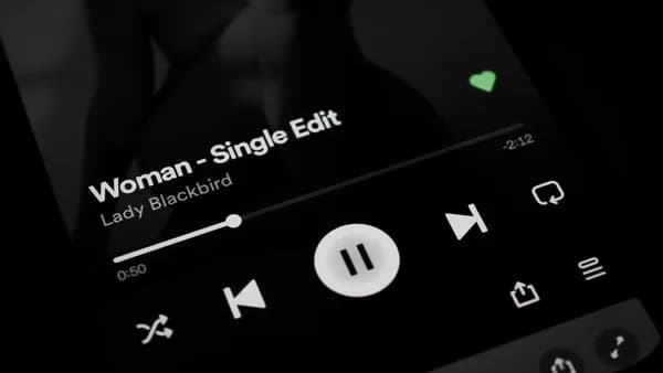 a close up of a cell phone with a music player on it