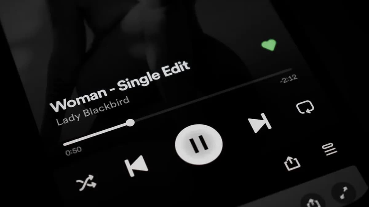 a close up of a cell phone with a music player on it