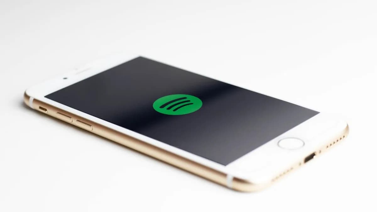 gold iPhone 7 displaying spotify logo