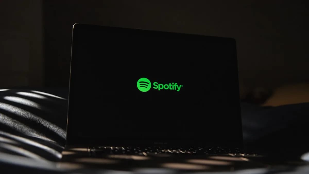 a laptop computer sitting on top of a bed