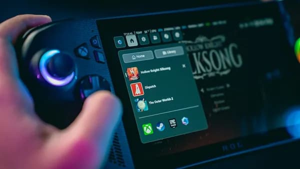 Hand holding a gaming device with game menu