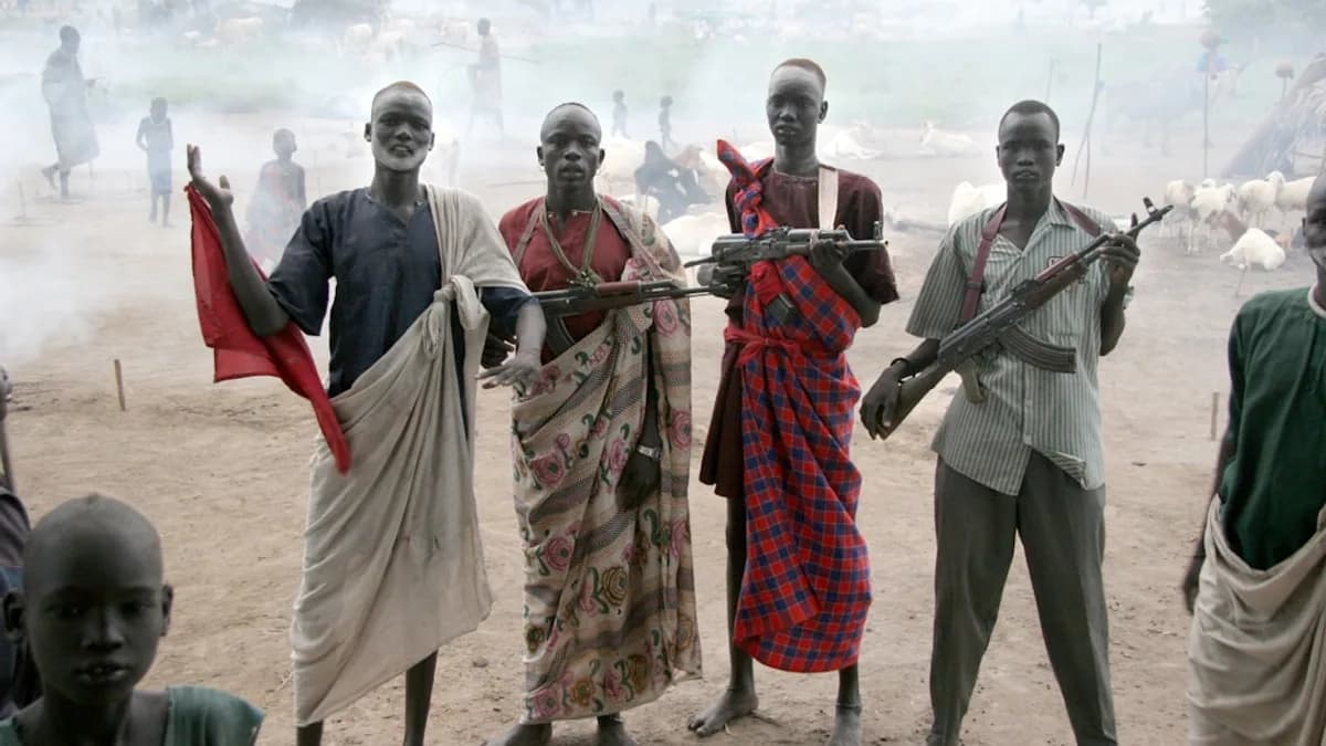 four men holding assault rifles
