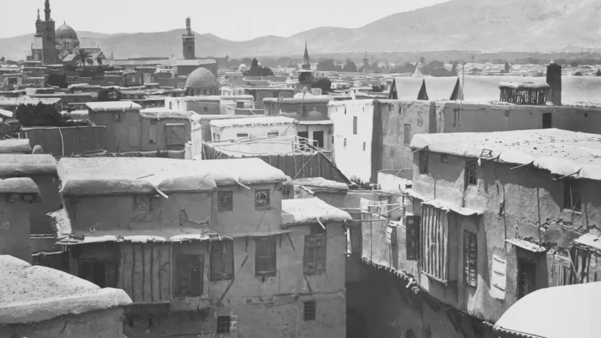 a black and white photo of a snow covered city