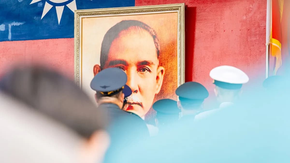 A portrait of a man in front of a flag