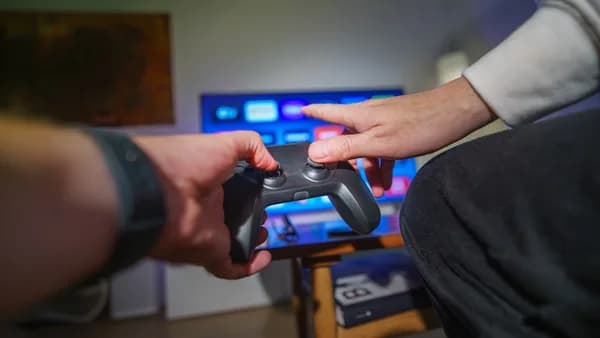 A person holding a video game controller in their hand