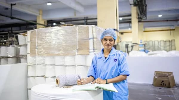 Woman working in a paper factory warehouse.